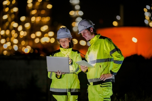Worker wearing high visibility workwear wearing a gas mask